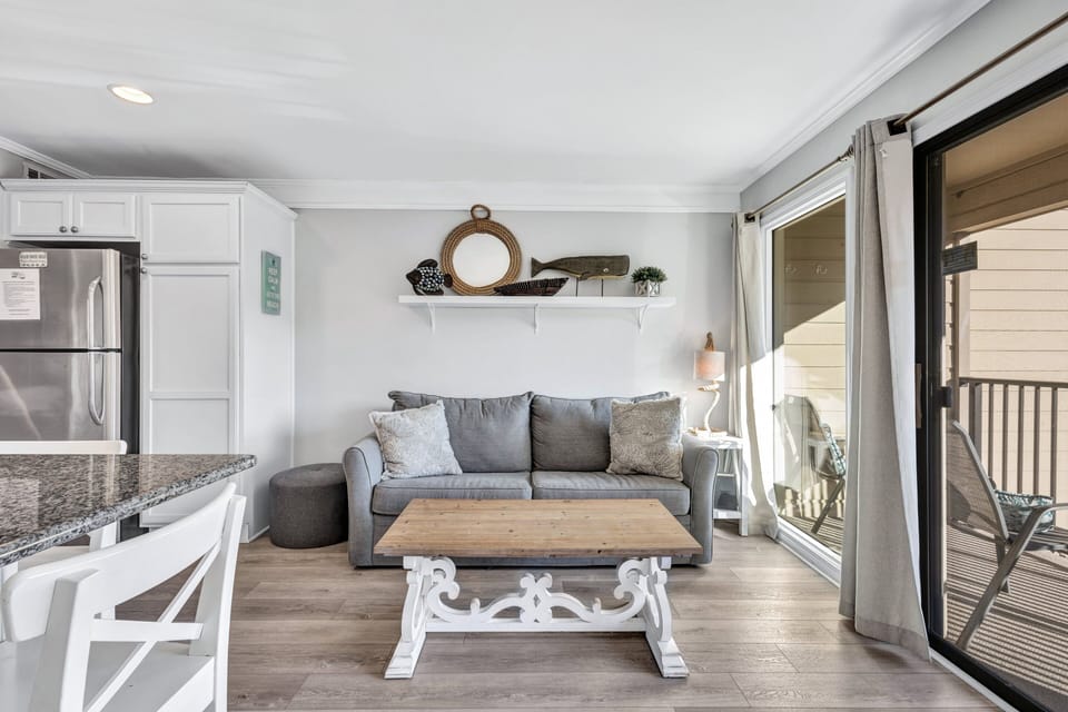 Step into the bright, airy living area with coastal decor, kick off your shoes, and relax into island time.