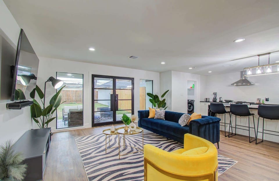 With plenty of natural sunlight streaming in through the large windows and patio doors, this living room is the perfect place to sit and unwind with your companions.