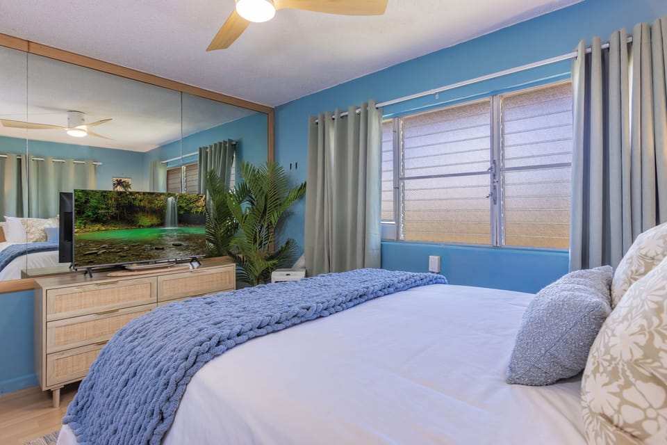 Unwind in this bright and inviting bedroom, featuring soothing coastal décor, a plush bed, and a tranquil atmosphere designed for restful nights and relaxing mornings.