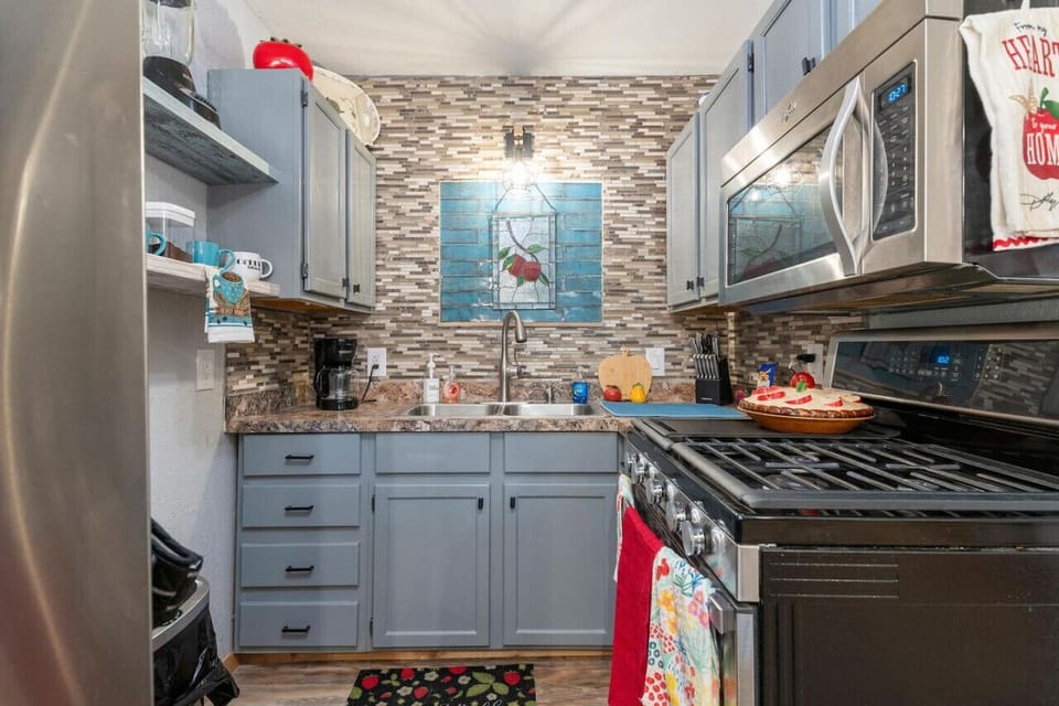 Full size kitchens ink with stove, microwave and refrigerator.