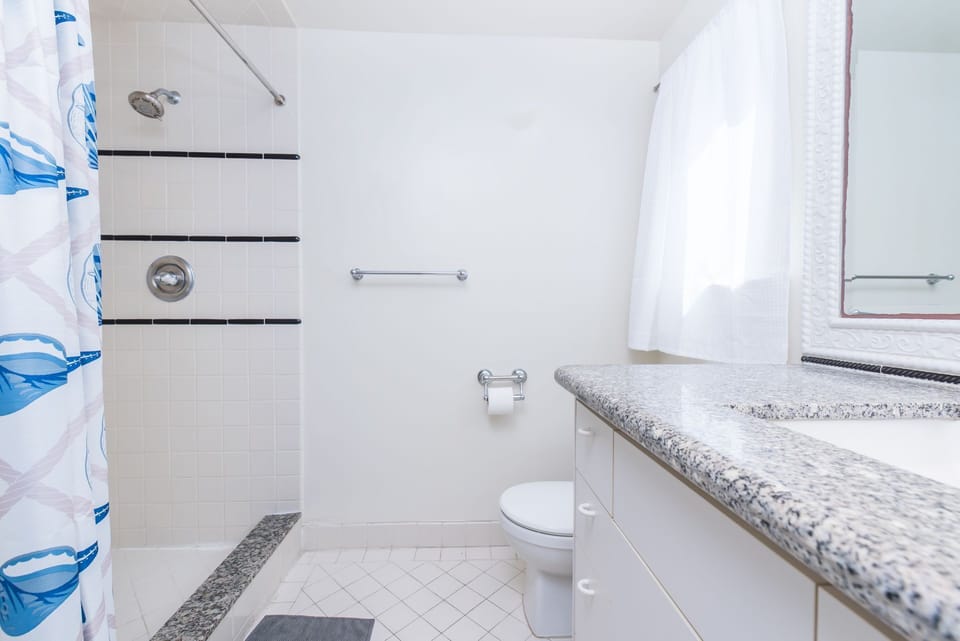 The primary bathroom offers a step-in shower and a sink to start your day.
                