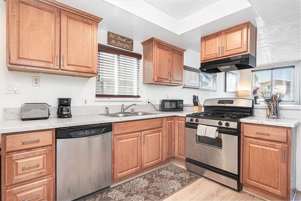 Fully equipped kitchen with warm-wood cabinetry and spacious layout
                