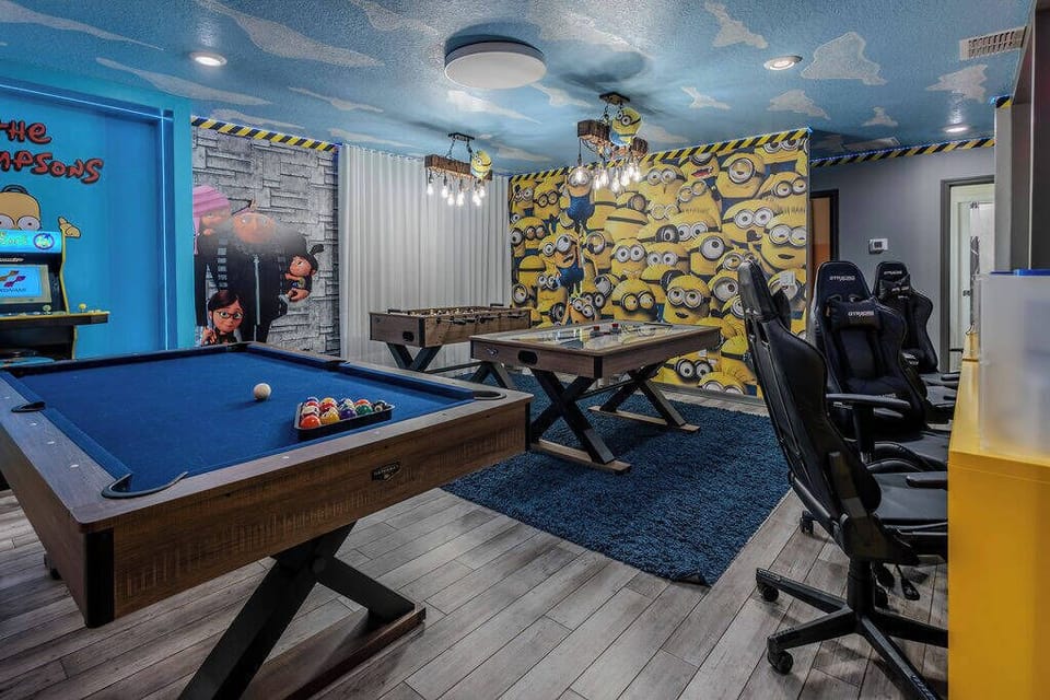 Experience our vibrant game room with a sleek pool table and foosball setup, ideal for friendly competition. Colorful murals and playful decor create a lively atmosphere, while modern chairs invite you to relax and enjoy the fun.