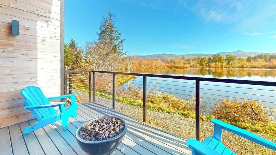 A private deck overlooking the pond awaits, complete with your own outdoor fire pit—perfect for relaxing and soaking in the coastal charm.