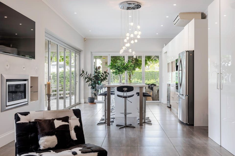 View from living room through kitchen out towards the bi-folds that open onto the BBQ area