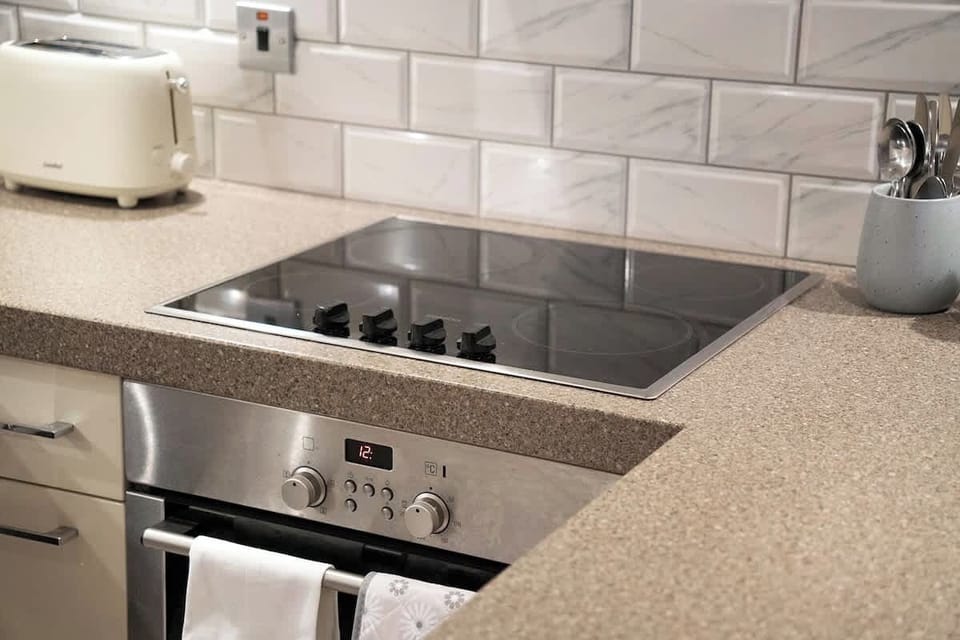 Kitchen equipped with all essentials, including a washer & dryer, oven, fridge and full cookware set.