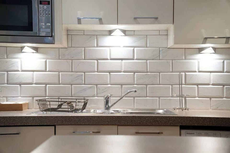 Kitchen equipped with all essentials, including a washer & dryer, oven, fridge and full cookware set.