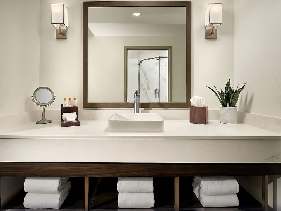 Prep with ease at the wide vanity and soft lighting.
