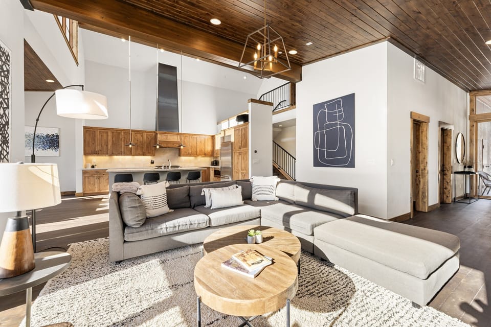 Relax in the inviting great room, where soaring ceilings and large windows flood the space with natural light while framing the picturesque mountain scenery. Cozy up by the stone fireplace and enjoy the 50" Smart TV.