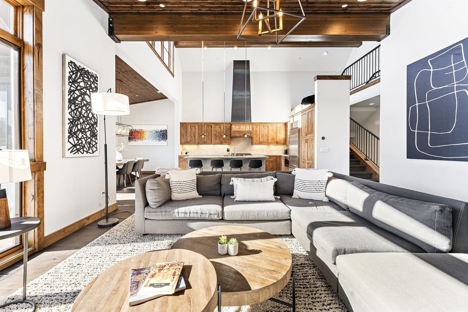 Relax in the inviting great room, where soaring ceilings and large windows flood the space with natural light while framing the picturesque mountain scenery. Cozy up by the stone fireplace and enjoy the 50" Smart TV.