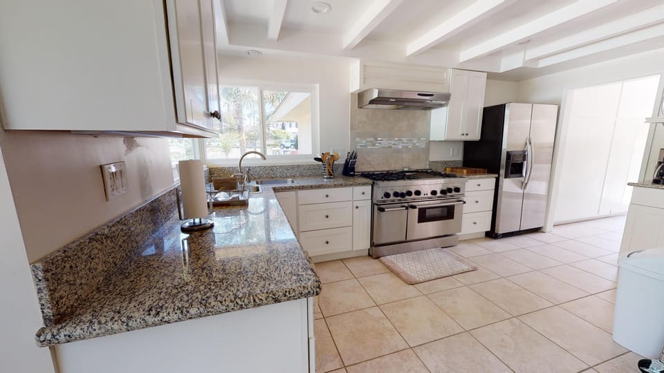 Kitchen features stainless steel appliances, and comes fully stocked