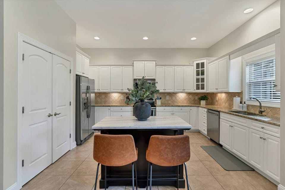 Spacious white kitchen with island
