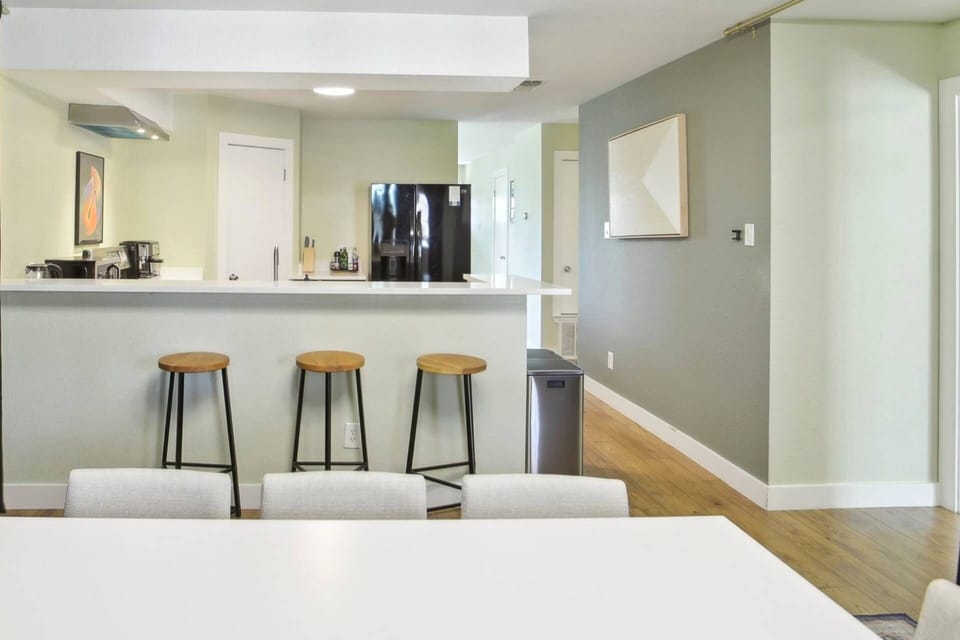 Open concept kitchen and dining with barstools by kitchen counter