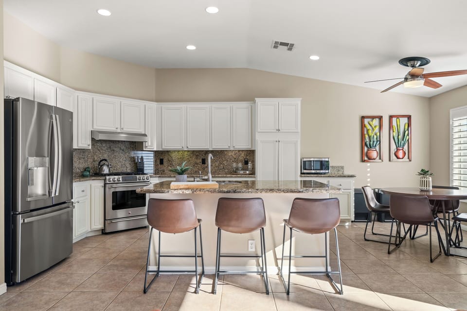 Fully equipped kitchen with barstool seating.