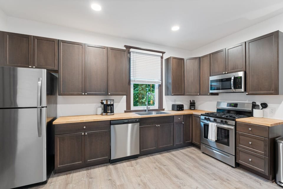 Our gourmet kitchen features stylish butcher block countertops and modern stainless steel appliances. It`s fully equipped with everything you need to prepare delicious meals.