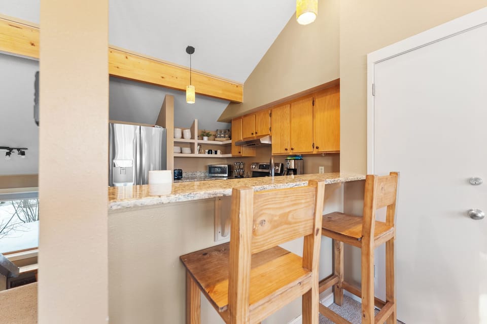 Your spacious kitchen features warm wood cabinetry and granite counters, perfect for cooking together.