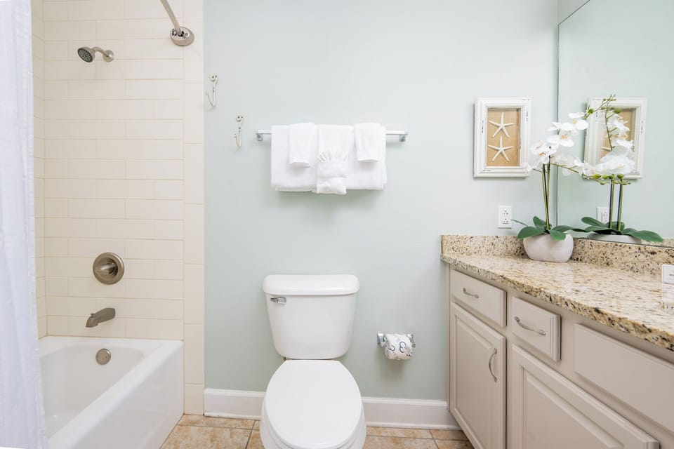 Refresh your spirit in the guest bathroom, where a soothing soak awaits after a day at the coast