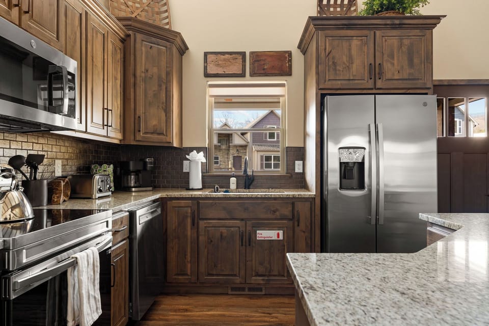Cook like you're at home! Our fully stocked kitchen features stainless steel appliances, pots, pans, utensils, dishes, spices, and small appliances like a blender and toaster. Perfect for everything from quick breakfasts to family dinners.