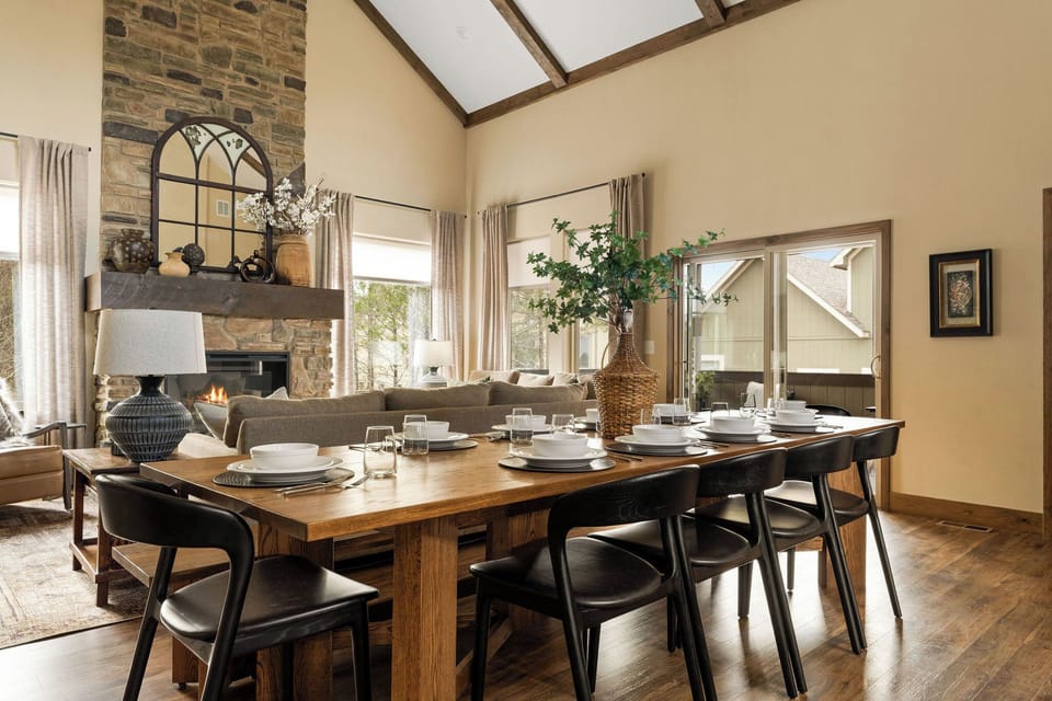 Gather around our custom dining table for meals, laughs, and chats. It seats 10, with additional seating for 4 at the kitchen island. Need placemats or coasters? They're in the kitchen's base corner cabinet