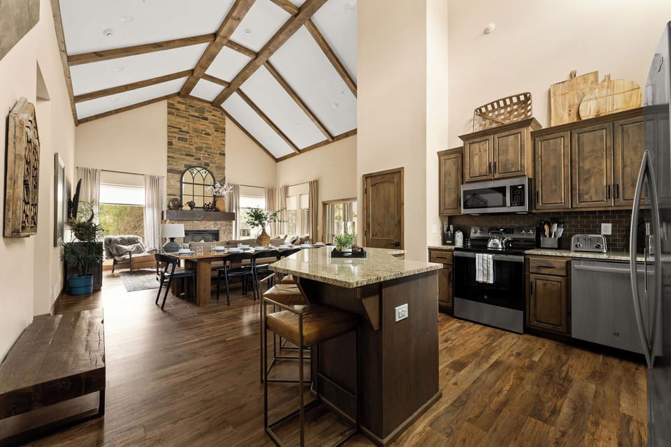 Welcome to Dogwood Canyon Lodge! Once inside, you'll be in the foyer + kitchen, while seeing into the dining and living room. The interiors are inspired by Dogwood Canyon Nature park. 