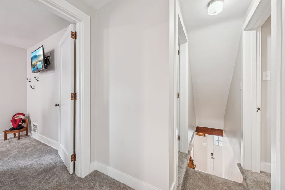 At the top of the stairs there is a landing w/ step into two bedrooms & hall