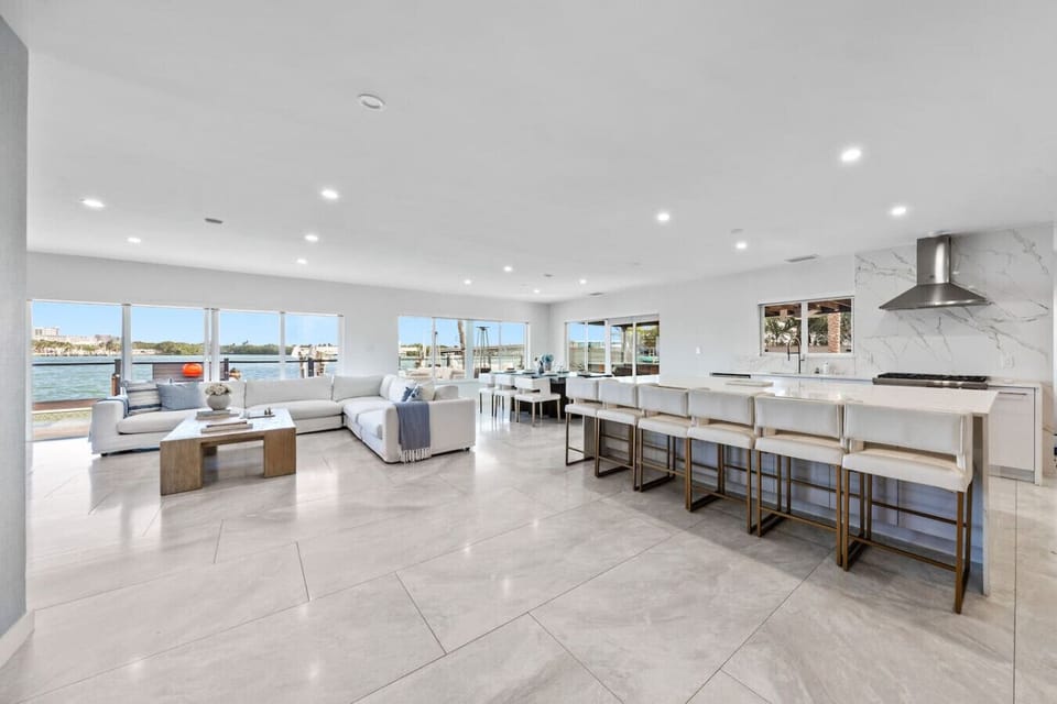 Contemporary luxury kitchen with seamless living integration and stunning harbor vistas