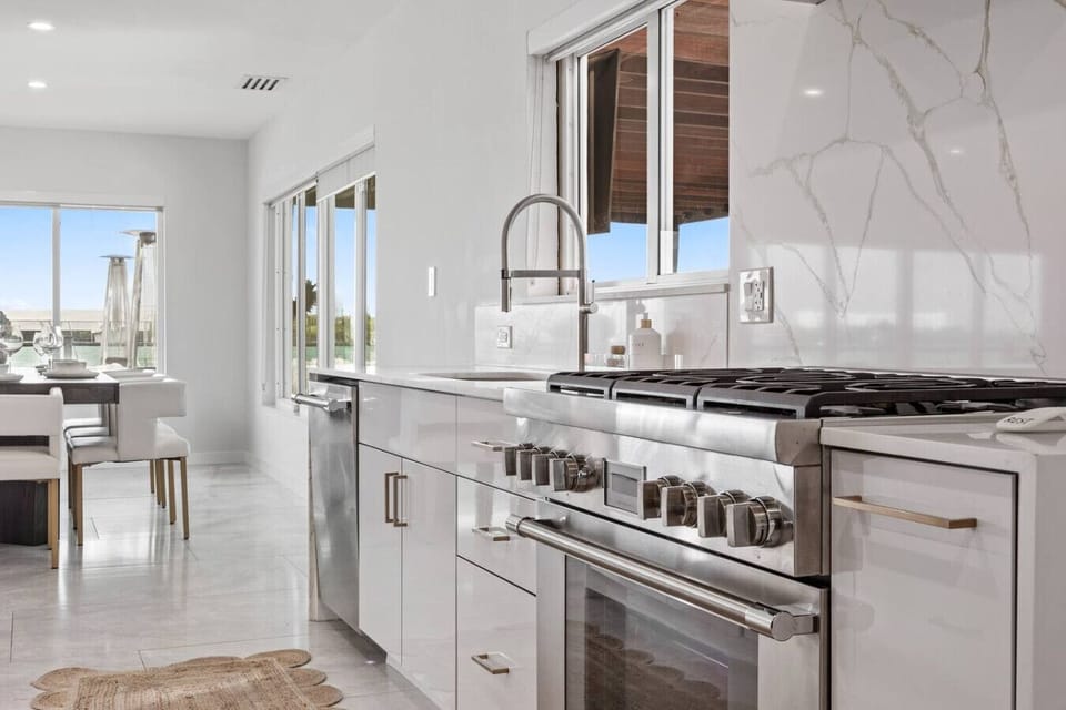 Contemporary culinary space with high end fixtures and stunning natural stone surfaces