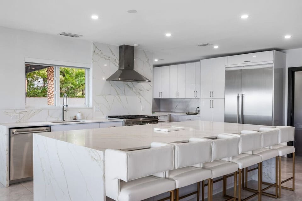 Contemporary culinary space with premium fixtures and stylish breakfast counter arrangement