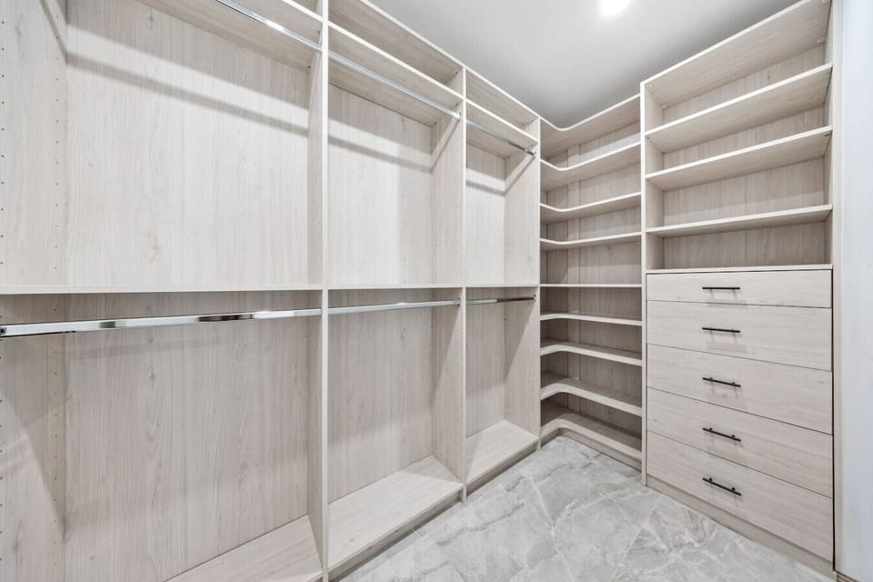 Luxury wardrobe space with warm timber elements and elegant organizational systems