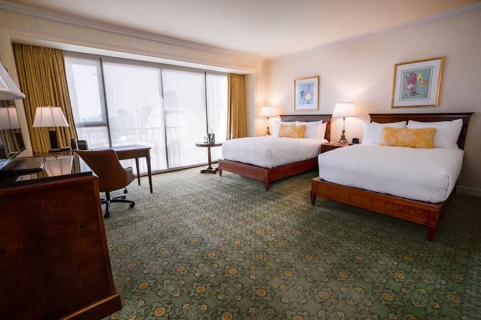 Gather everyone in a bright double-queen room with skyline views.