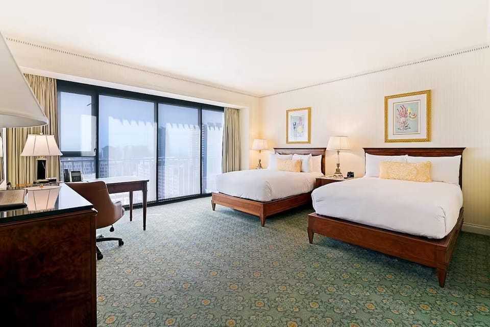 Wake up to city views from a roomy double-queen retreat.