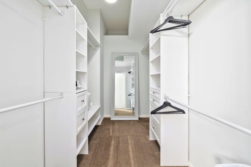 Primary closet with ample storage space