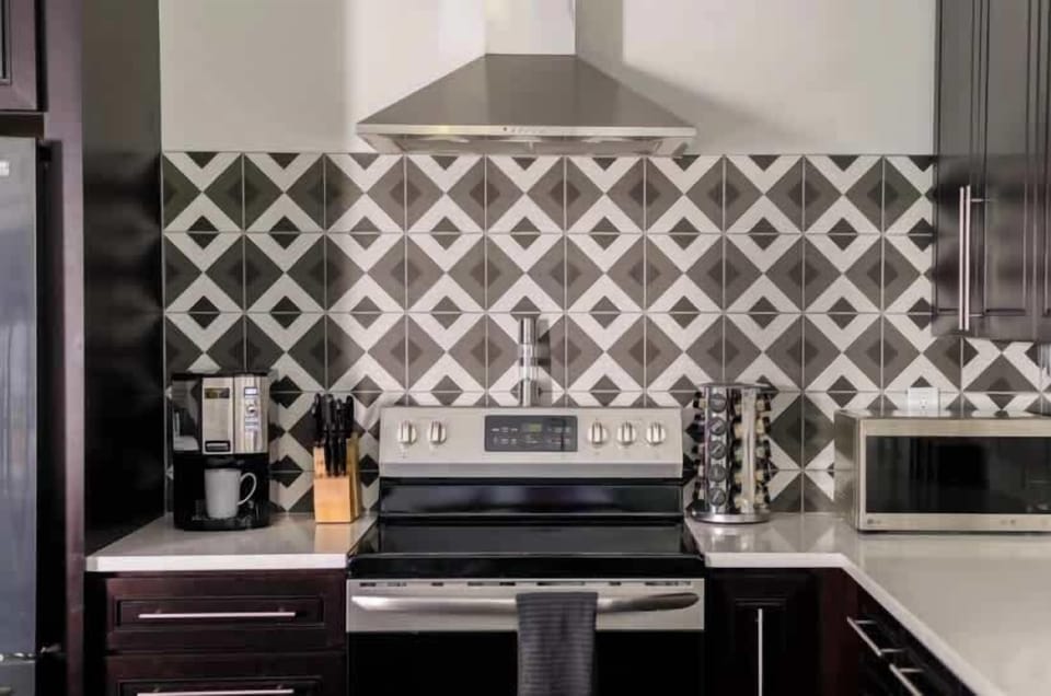Cook and gather in this modern kitchen, complete with sleek stainless steel appliances and a stylish island with seating for 3—perfect for sharing meals or casual conversations.