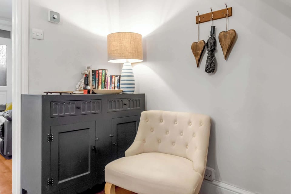 A single table with a collection of books, creating a cozy and inviting reading nook.