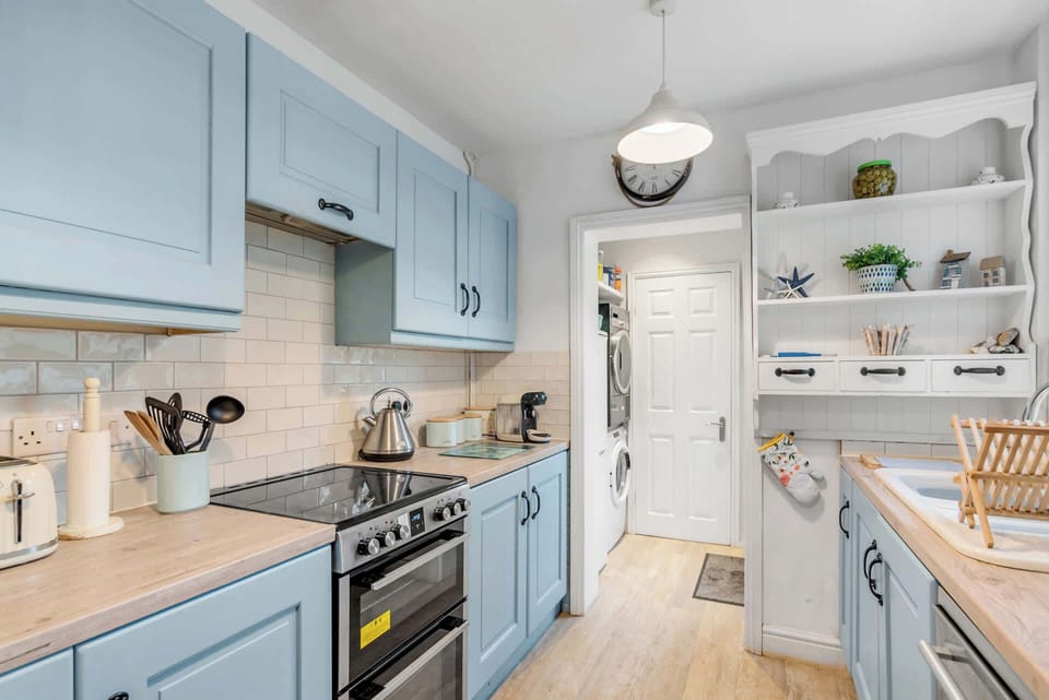 Fully equipped kitchen with modern appliances and sleek design.