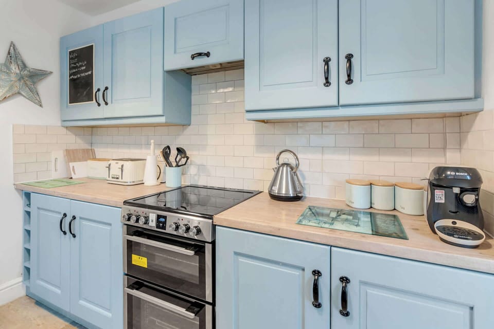 Fully equipped kitchen with modern appliances and sleek design.