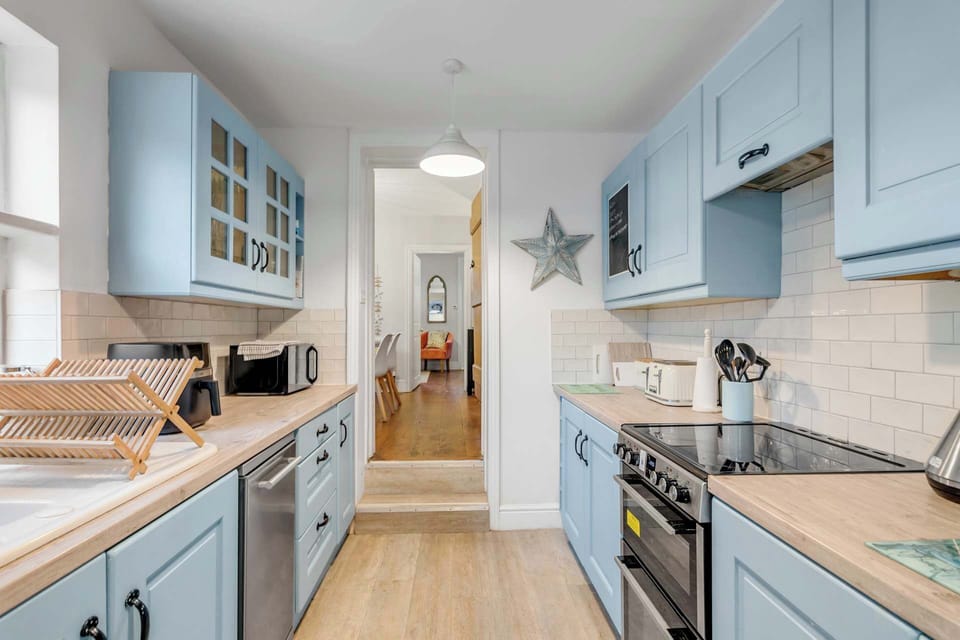 Fully equipped kitchen with modern appliances and sleek design.