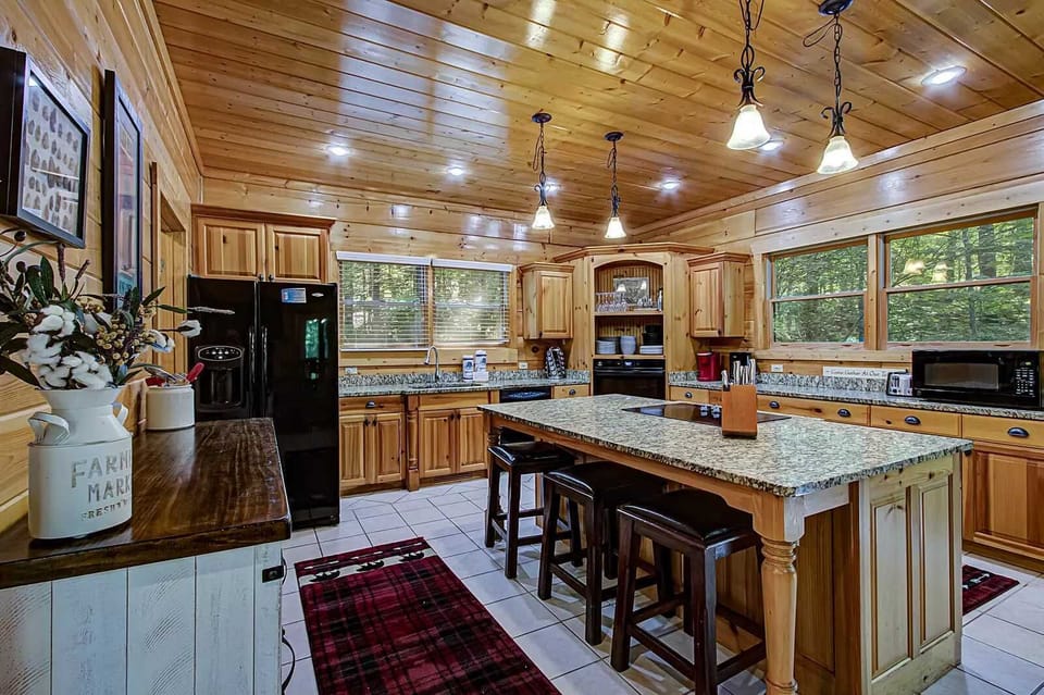 Culinary adventures await in this spacious, wood-lined kitchen with scenic views!
