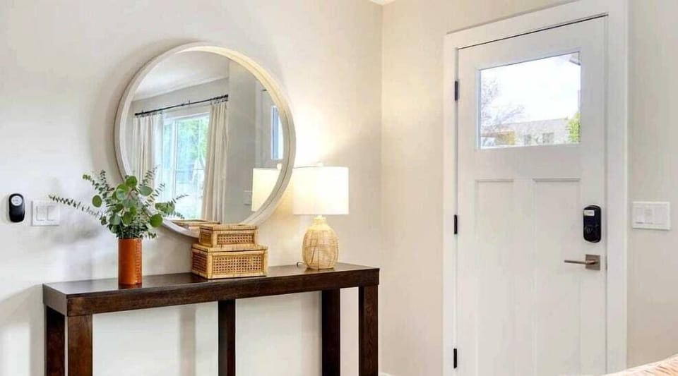 Bright open floor living space featuring a smart flat-screen TV, and designer furnishings.