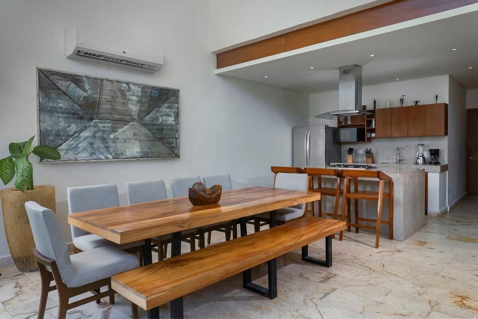 Luxurious open concept kitchen-dining area. The dining area features a modern design and space for all guests.
