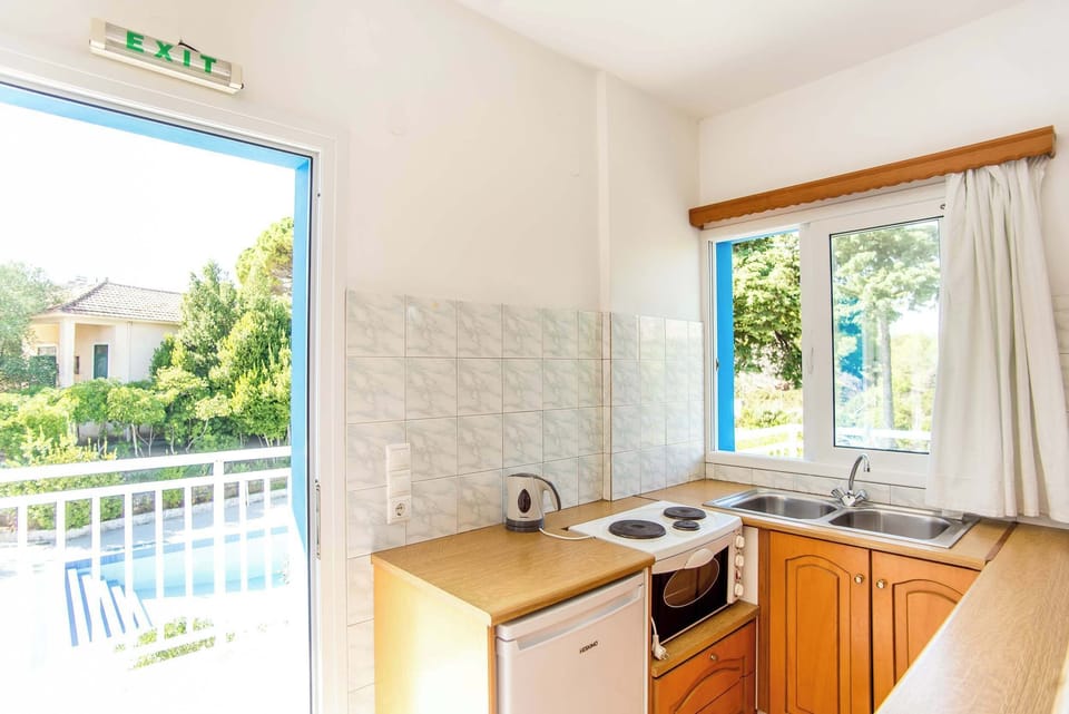 Kitchenette with essential appliances and natural light

