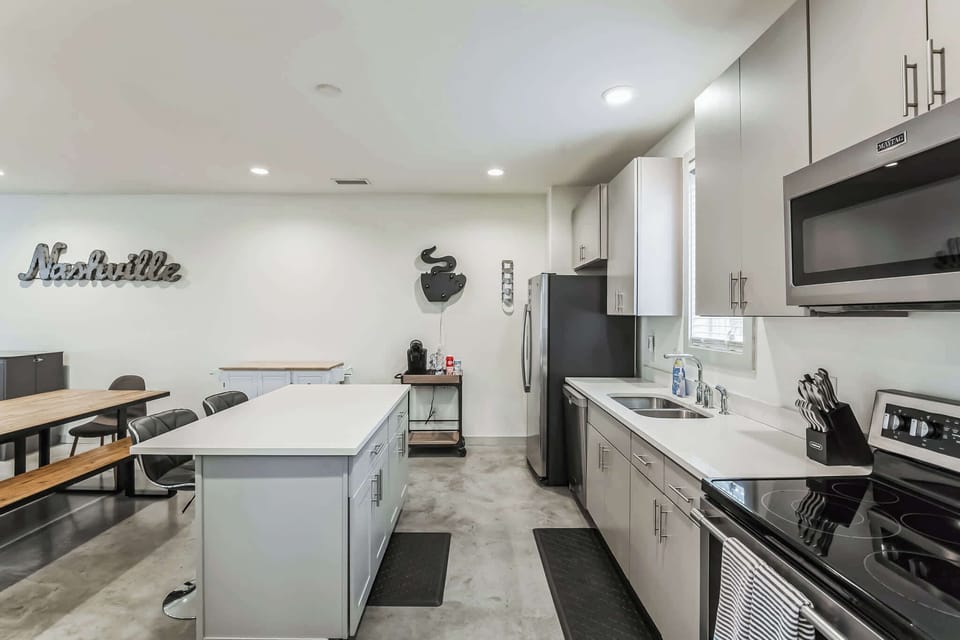 The sleek, open kitchen offers ample space & every home comfort