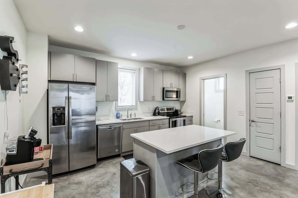The sleek, open kitchen offers ample space & every home comfort