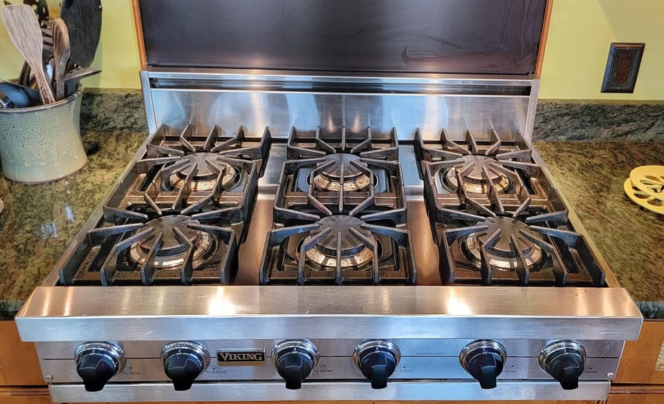  At the heart of the kitchen is a professional-grade 6-burner gas stove, designed for precision and power.