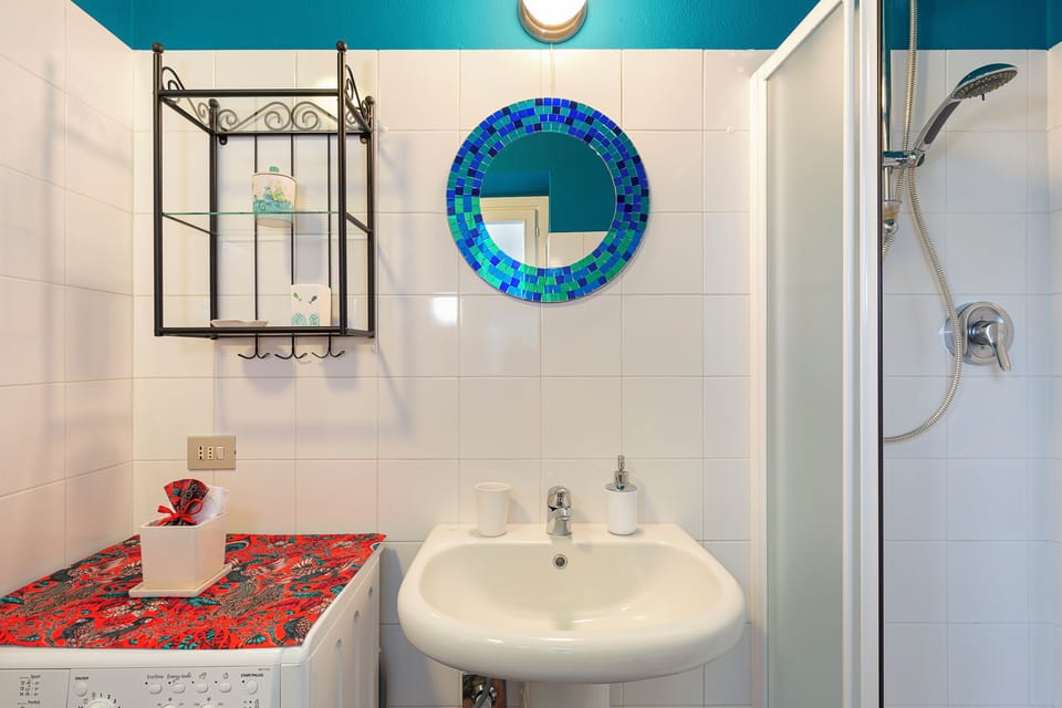 Bathroom with shower and washing machine
