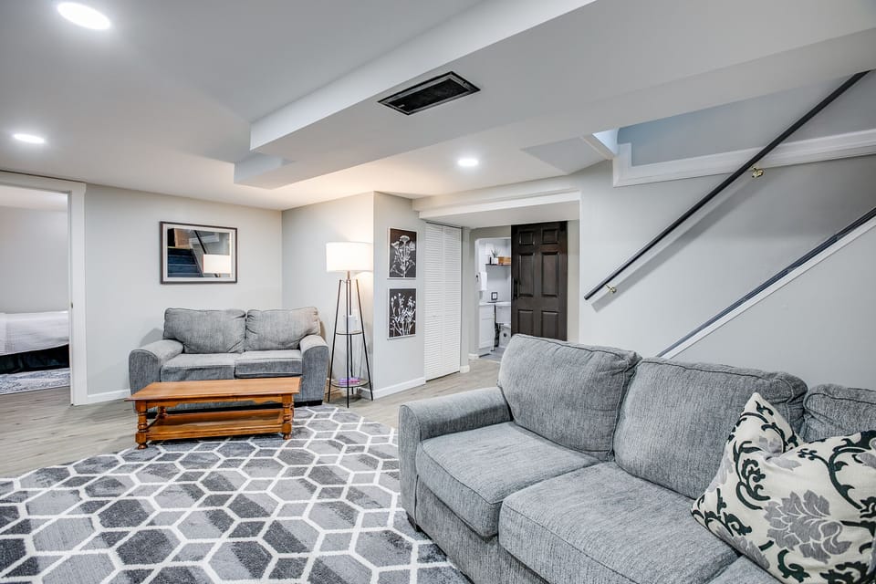 The second living area in the basement features a couch and loveseat.