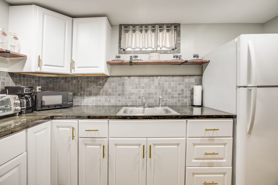 There's a second kitchen in the basement, with full-size fridge and sink, 2-burner stove, coffeemaker, microwave, and toaster oven.
