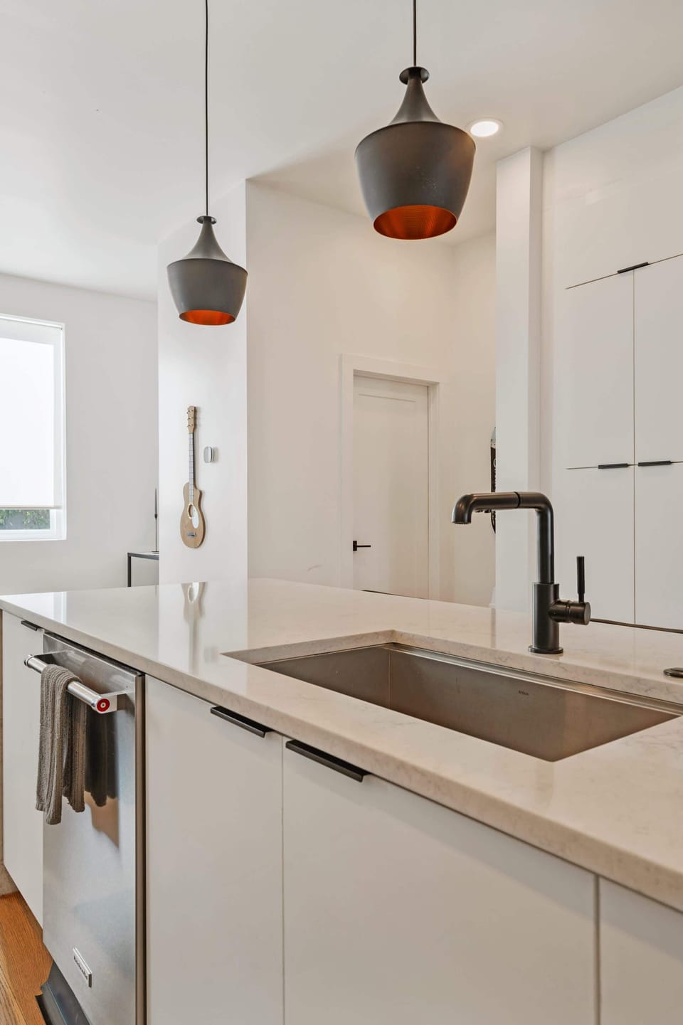 Kitchen island designed for cooking and cleanup with sink and dishwasher.