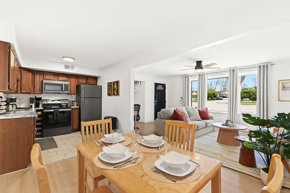 Gather around this sleek black dining table, beautifully set for your stay.