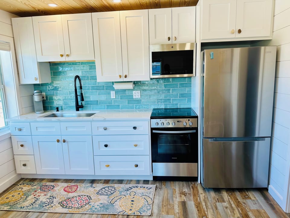 4 burner stove w/oven, complimentary coffee/coffee maker. Full size fridge.